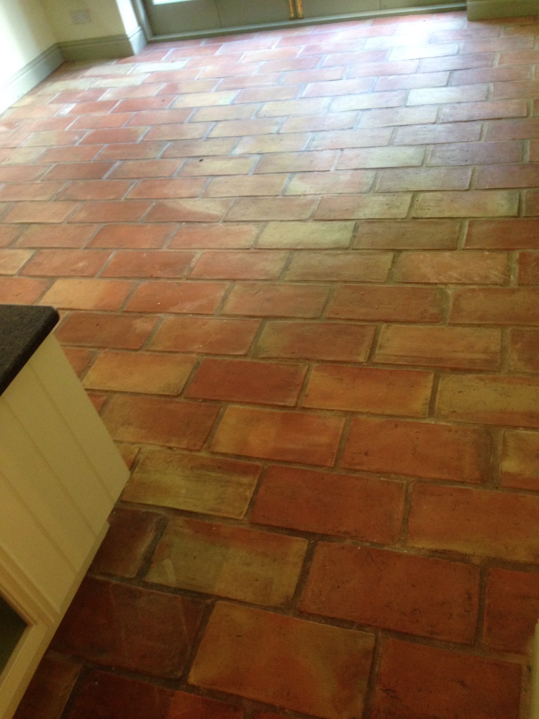 Terracotta brick tiled floor before cleaning in Alderly Edge